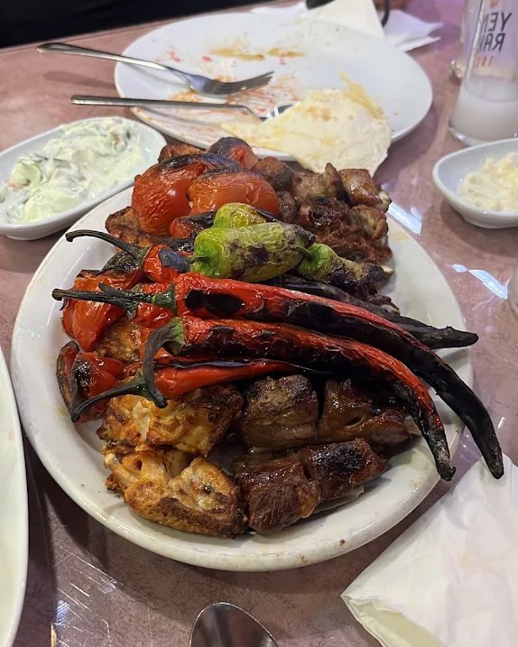 Mixed kebab platter — lamb, chicken, charred peppers and tomatoes, with sides