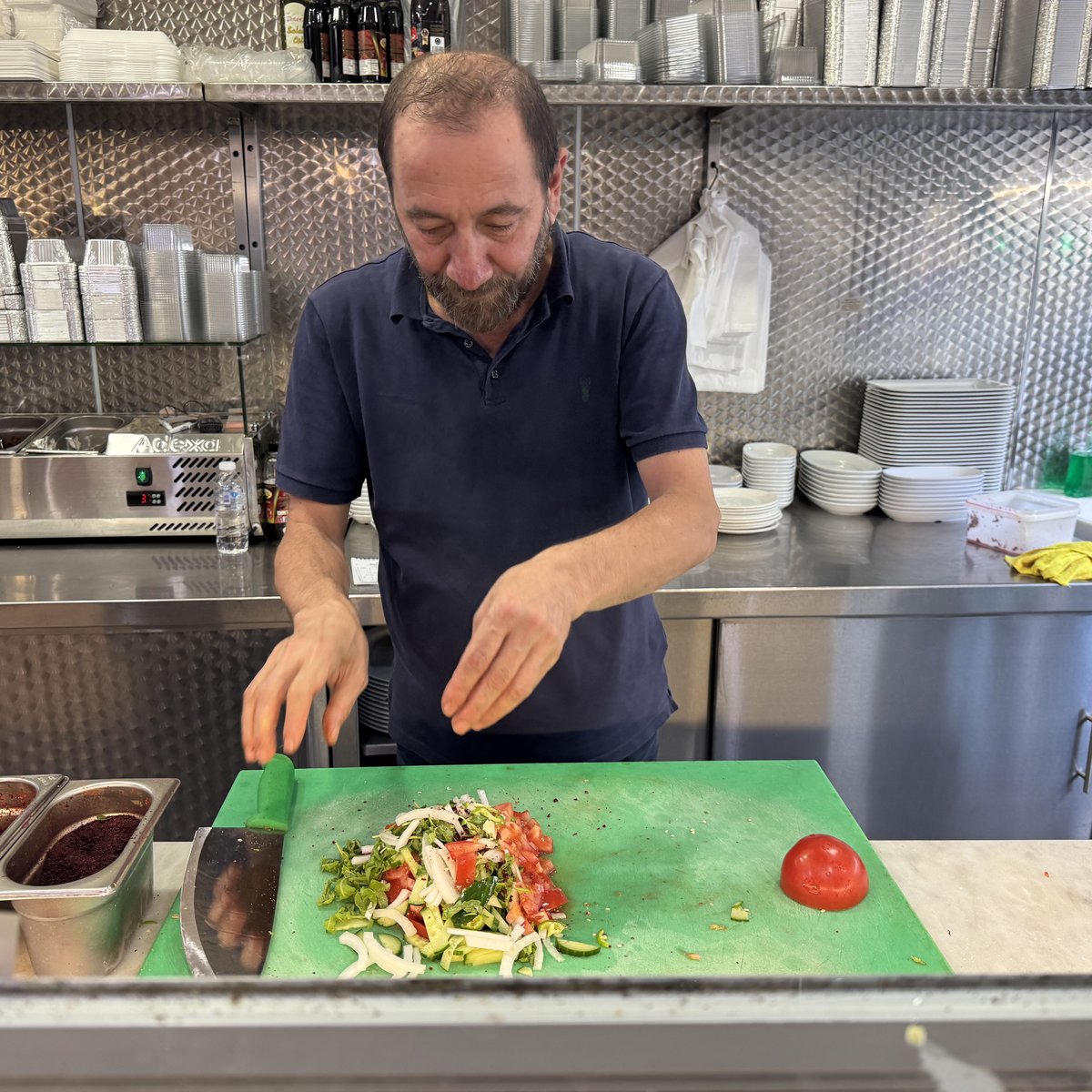 The owner of Kelebek Ocakbaşı at the charcoal grill